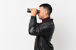 © luismolinero - Young man over isolated white background with black binoculars