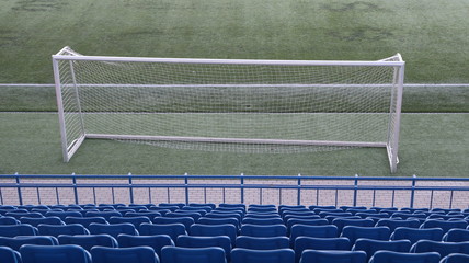 Wall Mural - stadium tribunes with football goal on green pitch