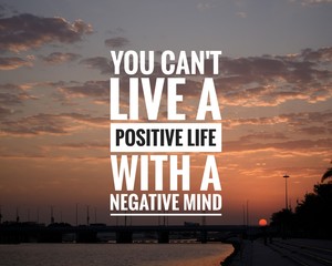 Wall Mural - Motivational Quote on sunset background - You can't live a positive life with a negative mind.