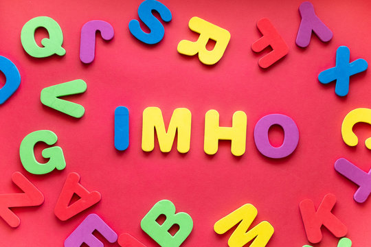 Abbreviation IMHO From Plastic Magnetic Letters On Red Background