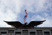 Low Angle View Of American Flag And Bald Eagle Statue On Us Embassy