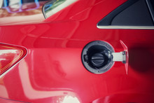A Close Up Image Of A Fuel Tank Cap On A Red Car