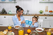 © Тарас Нагирняк - .Mom and daughter have breakfast in the morning at home. They eat cereal with milk.