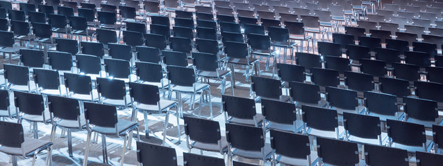 Empty seats. Equipped conference hall. Indoor business conference. Interior of a congress hall. Cancelled meetings, lectures, lessons, forums due to global disease. Online event. Web conference.