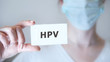 © loran4a - a doctor showing a signboard with the word HPV written in it
