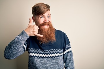 Poster - Handsome Irish redhead man with beard wearing winter sweater over isolated background smiling doing phone gesture with hand and fingers like talking on the telephone. Communicating concepts.