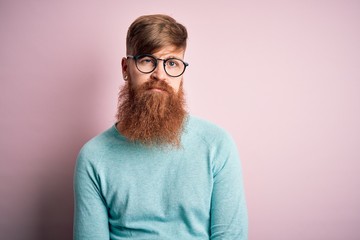 Poster - Handsome Irish redhead man with beard wearing glasses over pink isolated background looking sleepy and tired, exhausted for fatigue and hangover, lazy eyes in the morning.