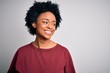 © Krakenimages.com - Young beautiful African American afro woman with curly hair wearing casual t-shirt standing looking away to side with smile on face, natural expression. Laughing confident.