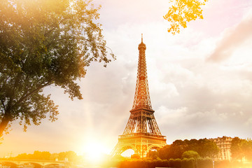 Romantic sunset background. Eiffel Tower with boats on Seine river in Paris, France.