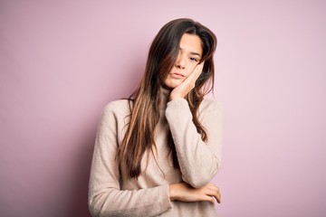 Canvas Print - Young beautiful girl wearing casual turtleneck sweater standing over isolated pink background thinking looking tired and bored with depression problems with crossed arms.