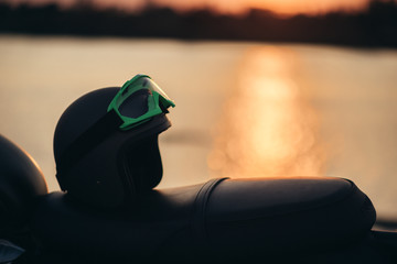 helmets and motorcycle with sunset light background