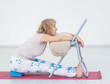Senior woman doing yoga with chair in a gym. Stretching exercises