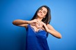 © Krakenimages.com - Young beautiful brunette woman wearing elegant and comfortable blue lingerie underwear smiling in love doing heart symbol shape with hands. Romantic concept.