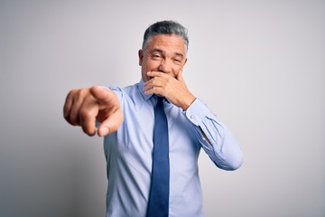 Poster - Middle age handsome grey-haired business man wearing elegant shirt and tie laughing at you, pointing finger to the camera with hand over mouth, shame expression