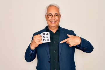 Sticker - Middle age senior grey-haired man drinking a coffee on best dad cup over isolated background with surprise face pointing finger to himself