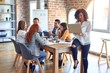 © Krakenimages.com - Group of business workers working together. Middle age beautiful businesswoman standing smiling happy looking at the camera at the office