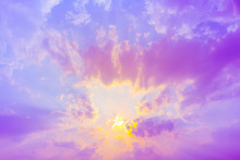 Bright Yellow Sun Light In Blue Sky With Purple Clouds