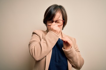 Sticker - Young down syndrome business woman wearing glasses standing over isolated background tired rubbing nose and eyes feeling fatigue and headache. Stress and frustration concept.