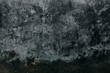Old rubber texture, looks like a ground. Black and gray wallpaper with with dust, scuffs and scratches, post-nuclear theme. Aged dirty surface.