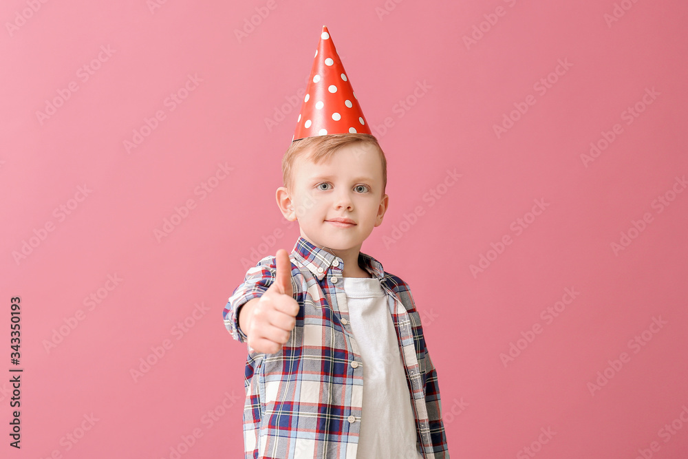 Cute little boy celebrating Birthday on color background