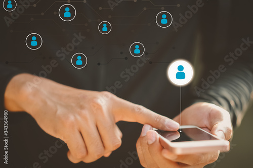 Man hand hold using smart phone at outdoor park street with people icon and line dot background Tableau sur Toile