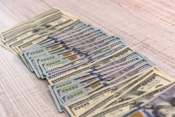 Wall Mural - Dollar banknotes in fan on wooden table close up