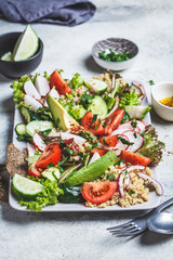 Poster - Quinoa salad with tomato, cucumber, radish and avocado on gray plate. Healthy vegan food concept.