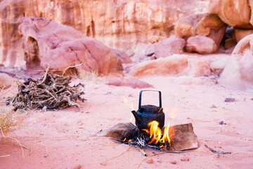 Making tea on bonfire in the desert of Wadi Rum, Jordan.