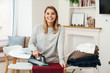 © Drobot Dean - Photo of cheerful woman housewife smiling while ironing clothes