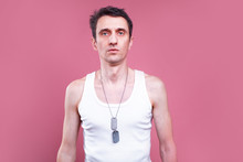 Serious Young Man Skinny And Pale Guy Posing On Camera. Isolated Over Pink Background. Man Stand Straight In Shirt. Get Ready For Exercises.