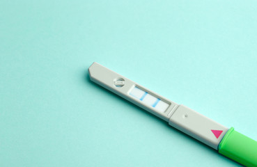 Pregnancy test on a blank colored background. Pregnancy, conception, and women's health. Birth of a baby concept