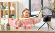 © Syda Productions - science, childhood and blogging concept - happy smiling girl with slime and camera on tripod recording video blog at home