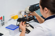 © Artur Ismailov - doctor looking into microscope, medicine concept. Checking blood test for viruses