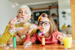 © Lumos sp - grandchild granddaughter grandma grandmother girl love family blowing soap bubble