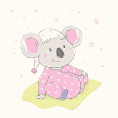  Lovely cute koala is sitting on the grass. Beautiful koala girl dressed in pink pajamas with hat.