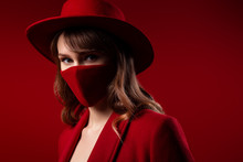 Elegant Woman Wearing Trendy Fashion Outfit During Quarantine Of Coronavirus Outbreak. Total Red Look Including Stylish Protective Handmade Face Mask. Close Up Studio Portrait. Copy Space For Text