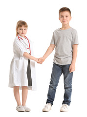 Poster - Cute little doctor with patient shaking hands on white background