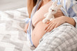 © Pixel-Shot - Beautiful young pregnant woman in bedroom