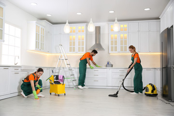 Wall Mural - Team of professional janitors cleaning modern kitchen