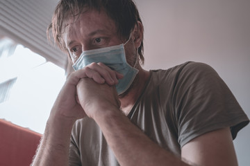 Worried stressed man self-isolated in home quarantine