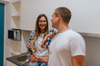 © Dragica - Beautiful young caucasian woman and handsome man chatting and drinking wine in the kitchen