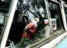 Santa Figurine In Abandoned Car Seen Through Window