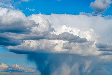 Wall Mural - Sun is higher than a rain cloud over the sea. Natural background.