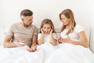 Poster - Photo of displeased caucasian parents scolding their stressed daughter