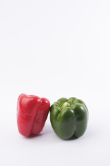 Wall Mural - Green and red bell pepper on white background