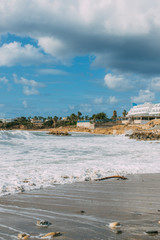 Wall Mural - White building near Mediterranean sea against blue and cloudy sky in Cyprus