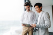 © Drobot Dean - Two business colleagues discussing new project while standing