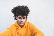 © Alessandro Biascioli - Afro smiling man portrait - Mixed race young guy with curly hair posing in front camera - Youth millennial generation culture and multiracial people concept