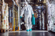 © Dusan Petkovic - Man in protective suit and mask disinfecting warehouse full of food products from corona virus / covid-19.