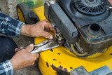 Fototapeta Mapy - repairing lawn mower engine in close up
